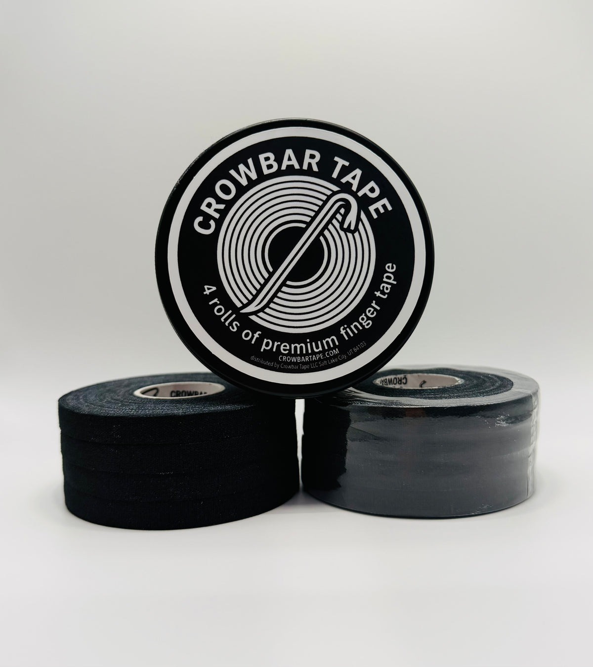 Two 4-pack rolls of black Crowbar Tape stacked on a light gray background, with a tin standing upright to show the black-and-white circular label that reads 'CROWBAR TAPE' and '4 rolls of premium finger tape '.