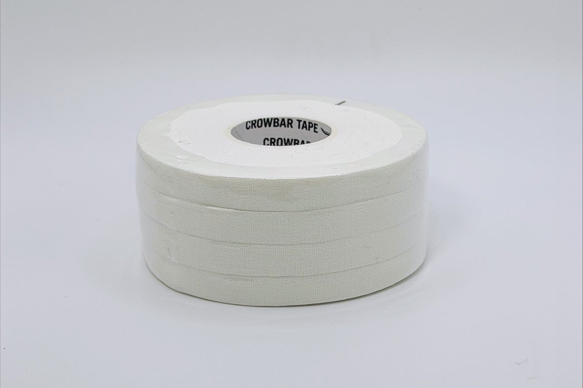 A roll of white crowbar tape with a whiteinner core, shown on a clean white background. The inner core has black text that reads 'CROWBAR TAPE CROWBAR'.